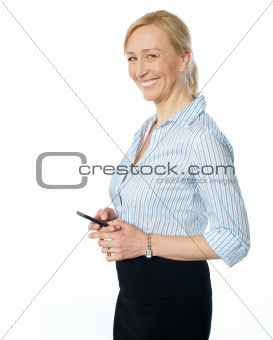 Beautiful corporate female using cellphone