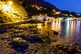 Illuminated Rocky Beach and Transparent Mediterranean Sea in the