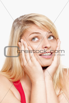 young woman with face in her hands thinking, looking - isolated on white