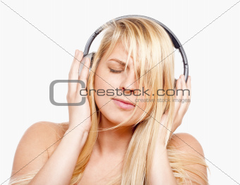 young girl listening to music in headphones - isolated on white