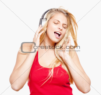 young girl listening to music in headphones - isolated on white