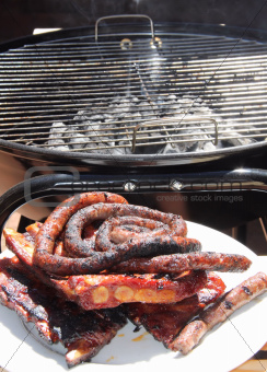 Ribs and sausages on a grill