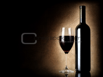 Wine bottle and wineglass on a old background