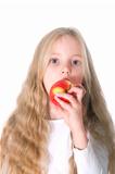 young blond girl biting in apple