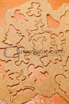 Gingerbread cookie dough with christmas themed shapes