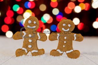 Gingerbread people with blurry christmas lights