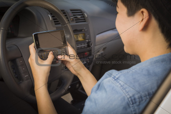Mixed Race Woman with Smart Phone Texting and Driving.