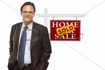 Businessman in Front of Sold Home For Sale Real Estate Sign Isolated on a White Background.