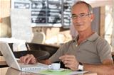 Grey-haired man in coffee shop