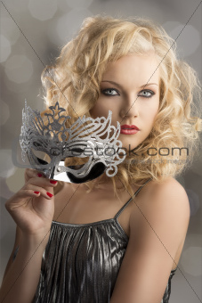 blonde girl with silver mask turned of three quarters