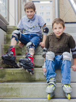 two smiling teenage boys in roller-blading protection kits
