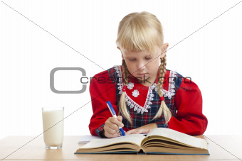 girl writing and a glass of milk