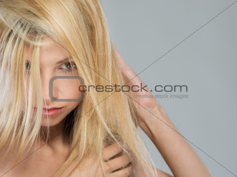 Portrait of blond girl with falling on face hair