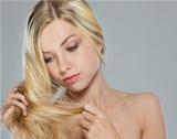 Portrait of blond girl checking hair ends