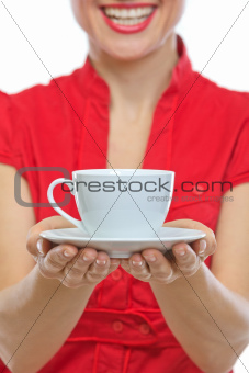 Closeup on smiling young woman holding cup