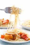 spaghetti hanging on a fork at dinner