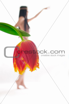 Naked girl on a white background with a tulip instead of a s