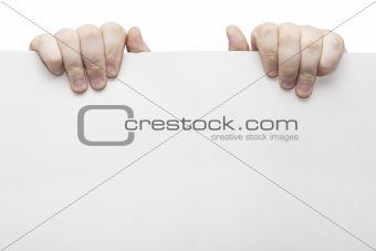 The two hands holding light grey cardboard paper