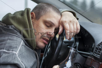 Drunk man lying on the steering wheel