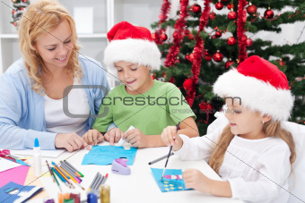 Family at christmas time making greeting cards