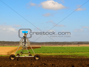 Agriculture Ploughed field with irrigation equipment