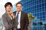 Attractive Mixed Race Woman and Businessman in Front of Corporate Building.