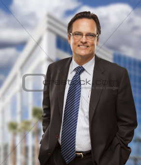 Handsome Businessman in Suit and Tie Smiling Outside of Corporate Building.