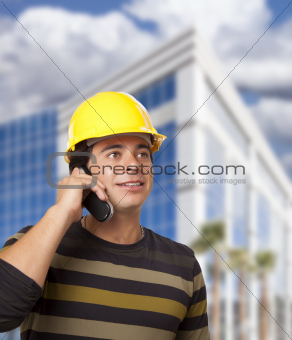 Handsome Hispanic Male Contractor on Cell Phone in Front of Corporate Building.