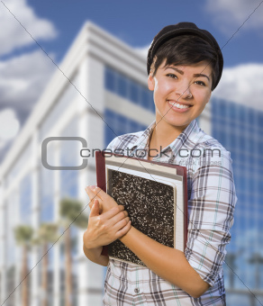 Attractive Mixed Race Female Student Holding Books in Front of Building.