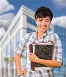 Attractive Mixed Race Female Student Holding Books in Front of Building.