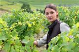 Young woman tending grapevines