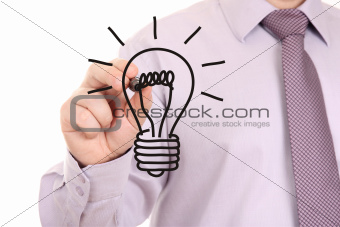 Businessman drawing light bulb