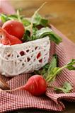 juicy organic radishes in a white basket