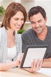 Happy Man & Woman Couple Using Tablet Computer at Home