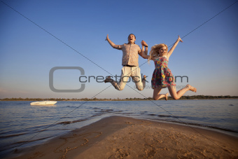 couple jumping on the beach