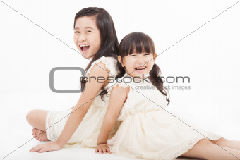 happy girls sitting on the white background