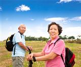 asian Senior couple hiking in countryside