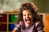 Happy female child smiling for joy in kindergarten