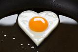 heart shaped egg in a frying pan