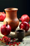 Ripe pomegranate and juice in cup.