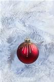 Red Christmas ball hanging on white tree