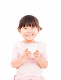 asian  little girl holding a glass of fresh milk 