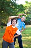 Happy asian senior fitness couple in the park