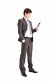 full length of Successful businessman holding smart phone isolat