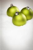 Beautiful Matt Green Christmas Ornaments on Snow Flakes Room For Your Own Text.