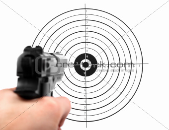 hand with gun shooting target