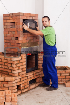 Worker building a masonry heater