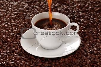 Hot coffee pouring into a cup