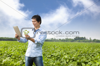 asian farmer with tablet pc