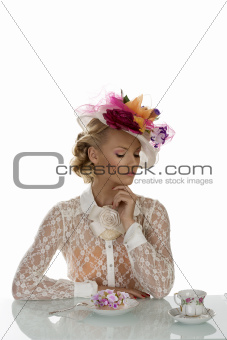 elegant girl with cake and cup of tea and closed eyes